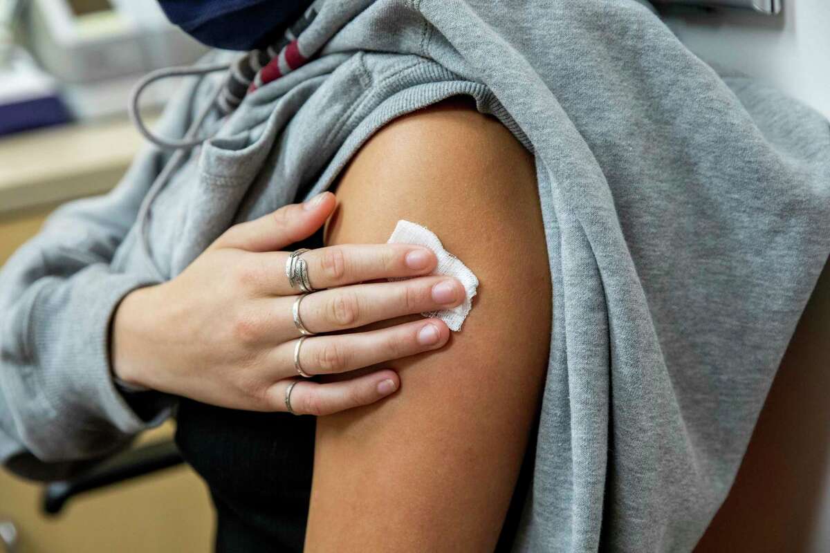 Elizabeth Worthington San Francisco, holds a gauze over her arm after receiving a flu vaccine at a CVS store in San Francisco, Calif. Now that vaccines have been authorized for children ages 5 to 11, some CVS and Walgreens have begun accepting appointments.