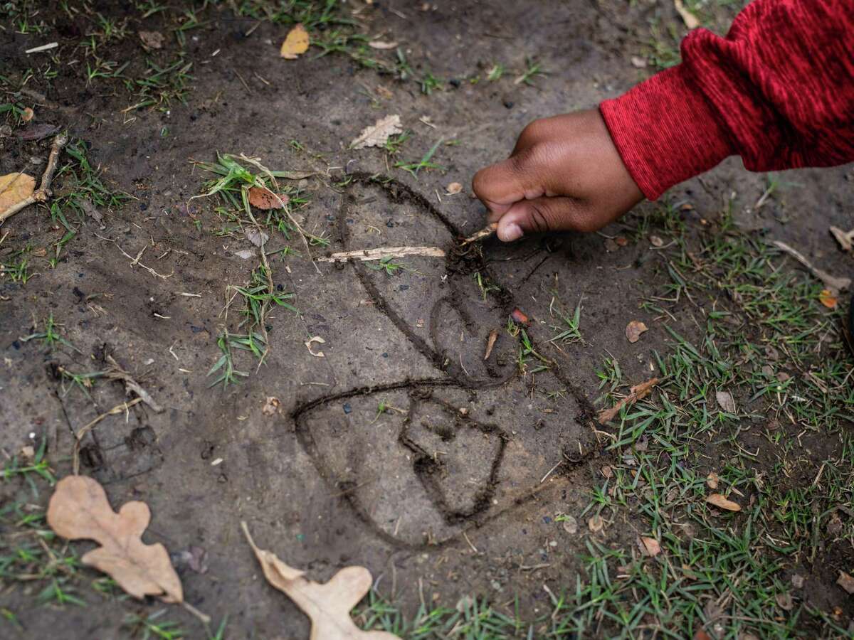 FILE PHOTO — A child receiving services at the Clarity Child Guidance Center in San Antonio draws a heart with a depiction of his mom and dad in the middle, during recreation time on Friday, November 22, 2019.