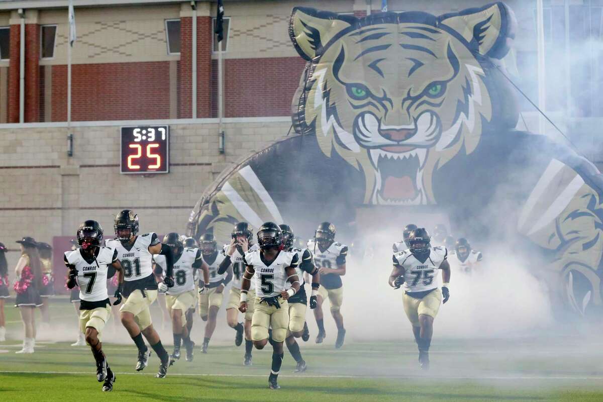 Conroe players do their tunnel run to take the field before their 13-6A district high school football game against Grand Oaks at Woodforest Bank Stadium Thursday, Oct. 14, 2021 in Shenandoah, TX.