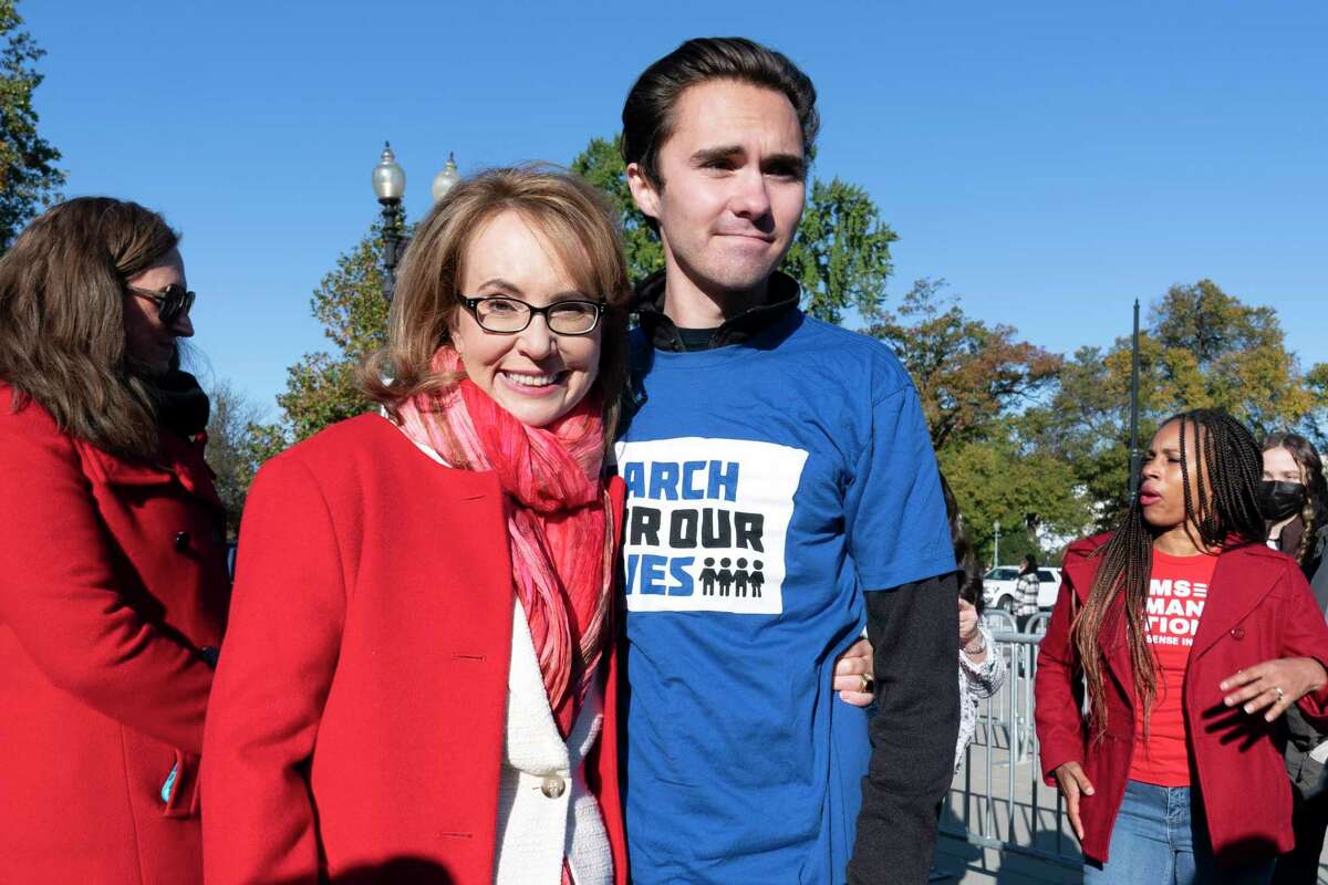Gun violence survivor and former U.S. Rep. Gabby Giffords, D-Ariz., speaks with Parkland, Fla., high school shooting survivor and activist David Hogg during a rally against gun violence outside of the U.S. Supreme Court in Washington on Wednesday. The court hear darguments in a gun rights case that centers on New York’s gun permit law.