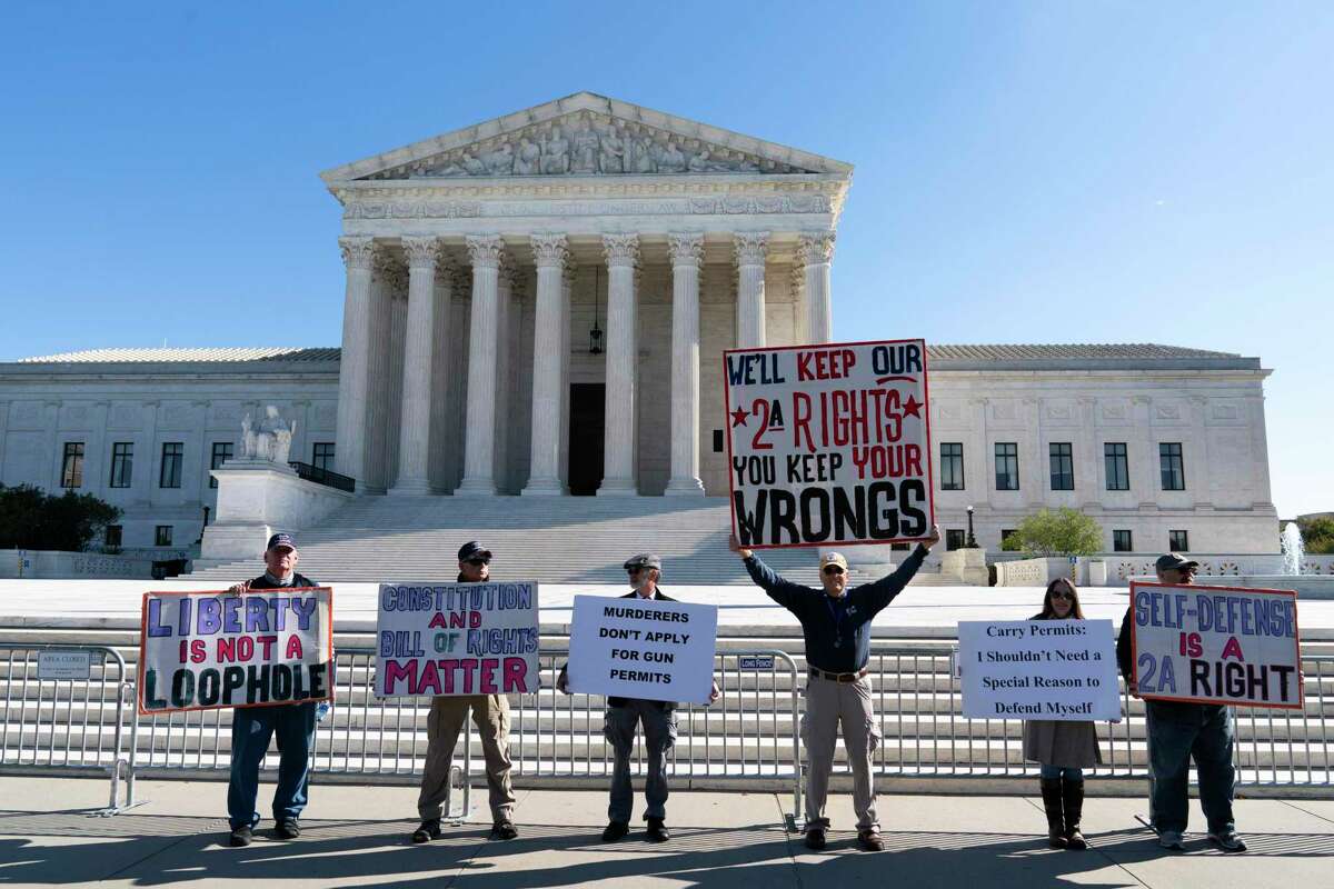 Demonstrators rally outside the U.S. Supreme Court on Wednesday. The court listened to arguments in a case that could strike down New York’s law on carrying concealed guns in public. The decision could affect California’s law as well.