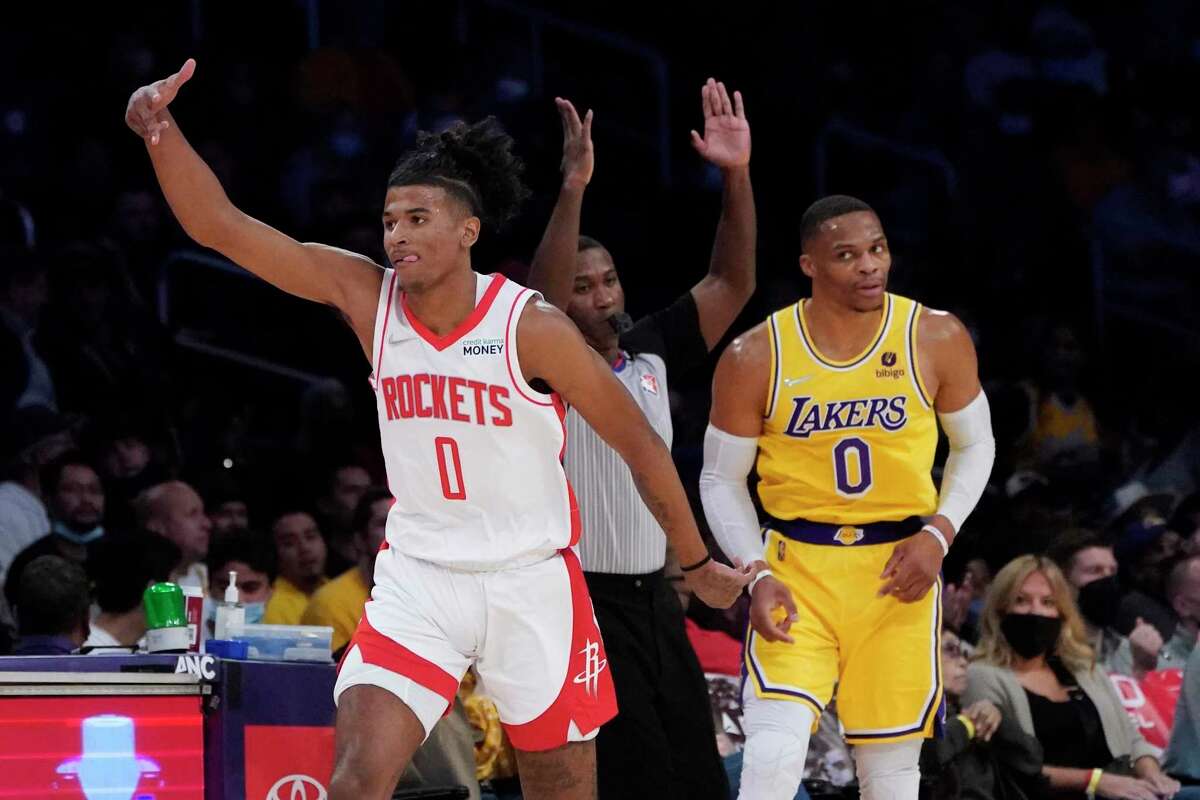 Houston Rockets guard Jalen Green, left, gestures after a making a three-point basket next to Los Angeles Lakers guard Russell Westbrook during the first half of an NBA basketball game Tuesday, Nov. 2, 2021, in Los Angeles. (AP Photo/Marcio Jose Sanchez)