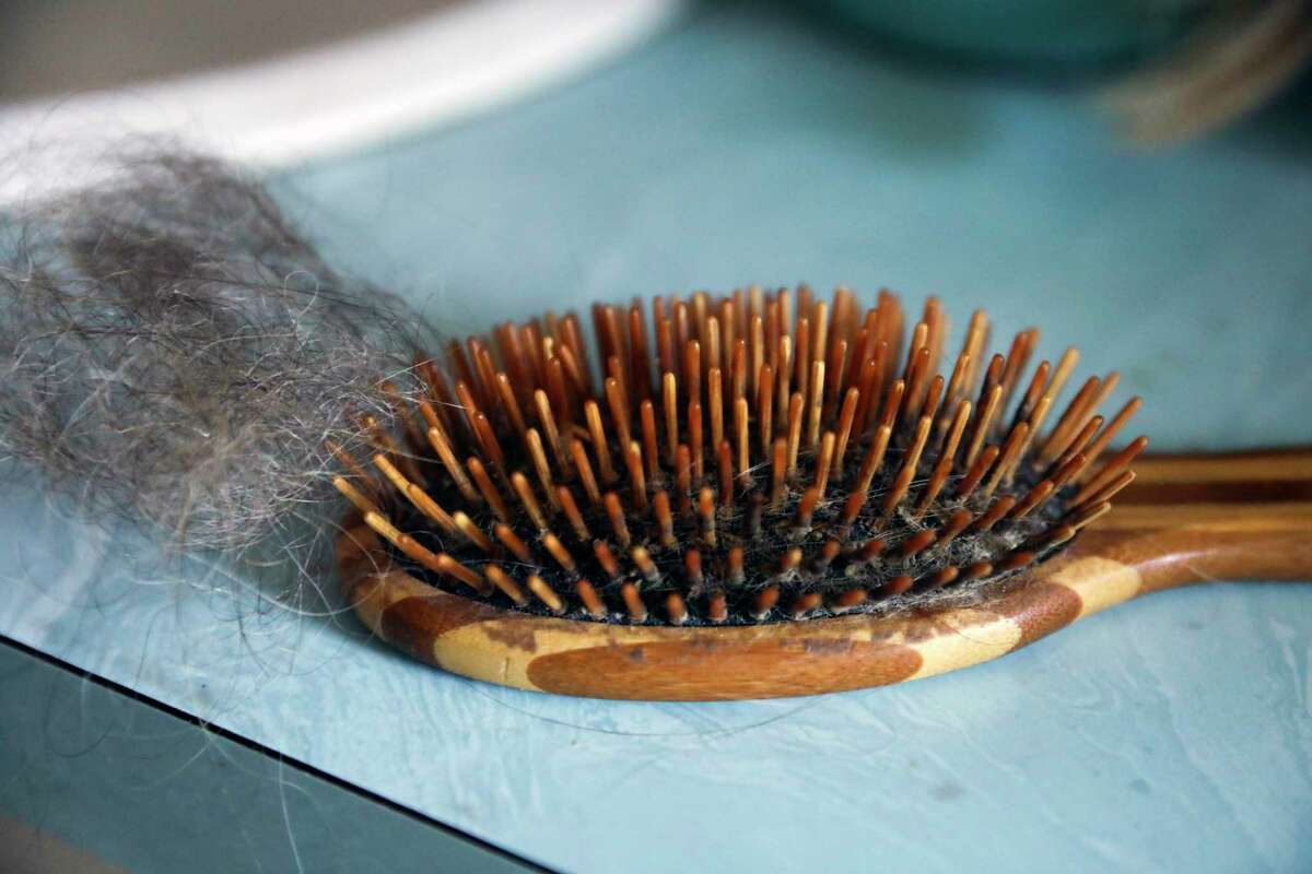 Annrene Rowe's hairbrush at her home in Anna Maria, Fla., on Sept. 18, 2020. Rowe was hospitalized for 12 days with coronavirus symptoms earlier this year; since then, she has noticed her hair falling out in clumps.(Eve Edelheit/The New York Times)
