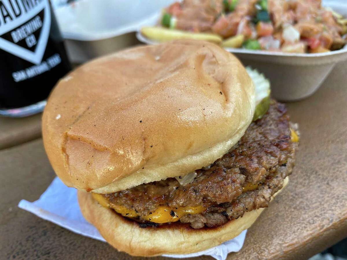 A double cheeseburger made with Impossible vegan beef patties from Project Pollo is seen in the photo. The chain closed its flagship location outside of Roadmap Brewing Co. on Monday.