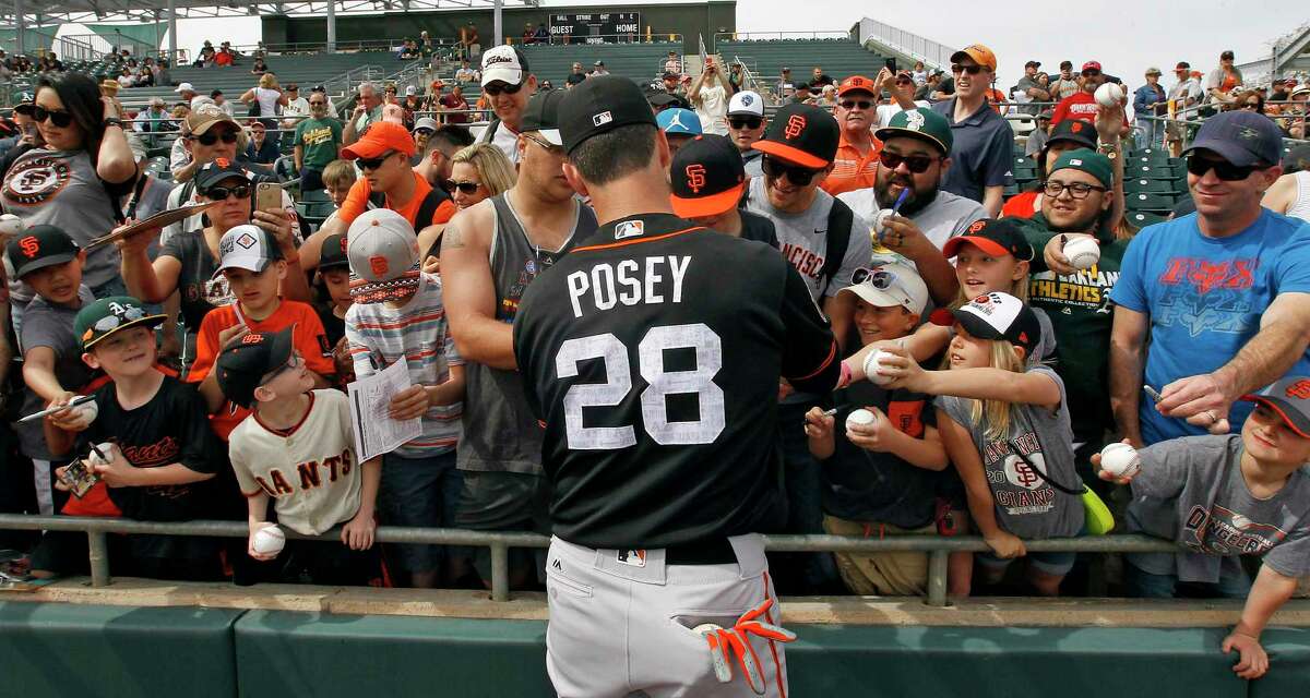 San Francisco Giants catcher Buster Posey signs autographs for fans before a Spring Training game against the Oakland Athletics at Hohokam Stadium in Mesa, AZ. on Friday, March 3, 2017. With the hyper-partisan political climate, players are hesitant to talk politics or voice their views in order to keep team unity and chemistry in the clubhouse.