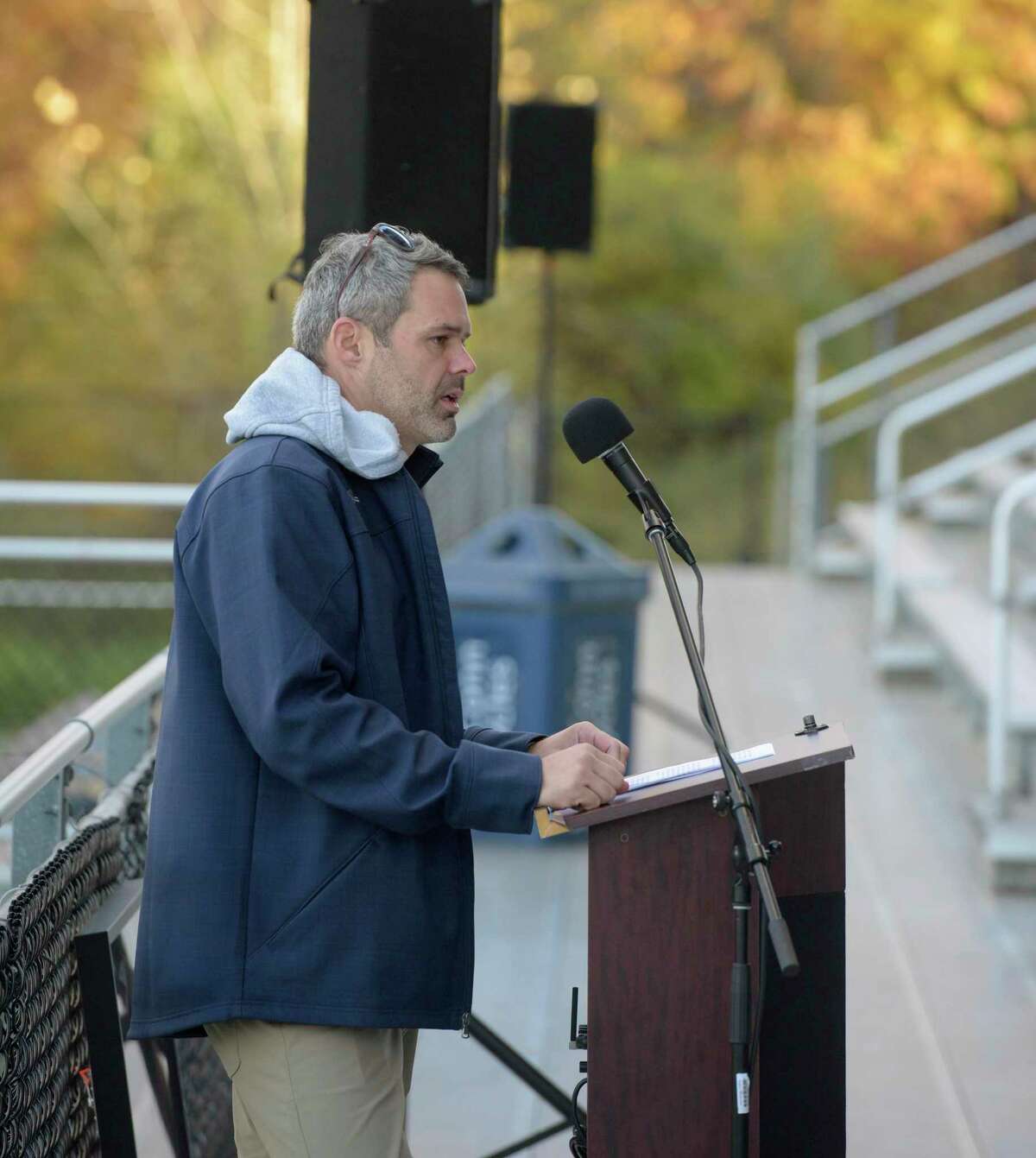 Lacrosse head coach Ryan Cavanaugh speaks at the memorial vigil to honor Western Connecticut State University lacrosse players Tyler Graham and Jacob Chapman who died in a car crash in October. Held in the Western Athletic Complex on the Westside Campus, Wednesday, November 3, 2021, Danbury, Conn.