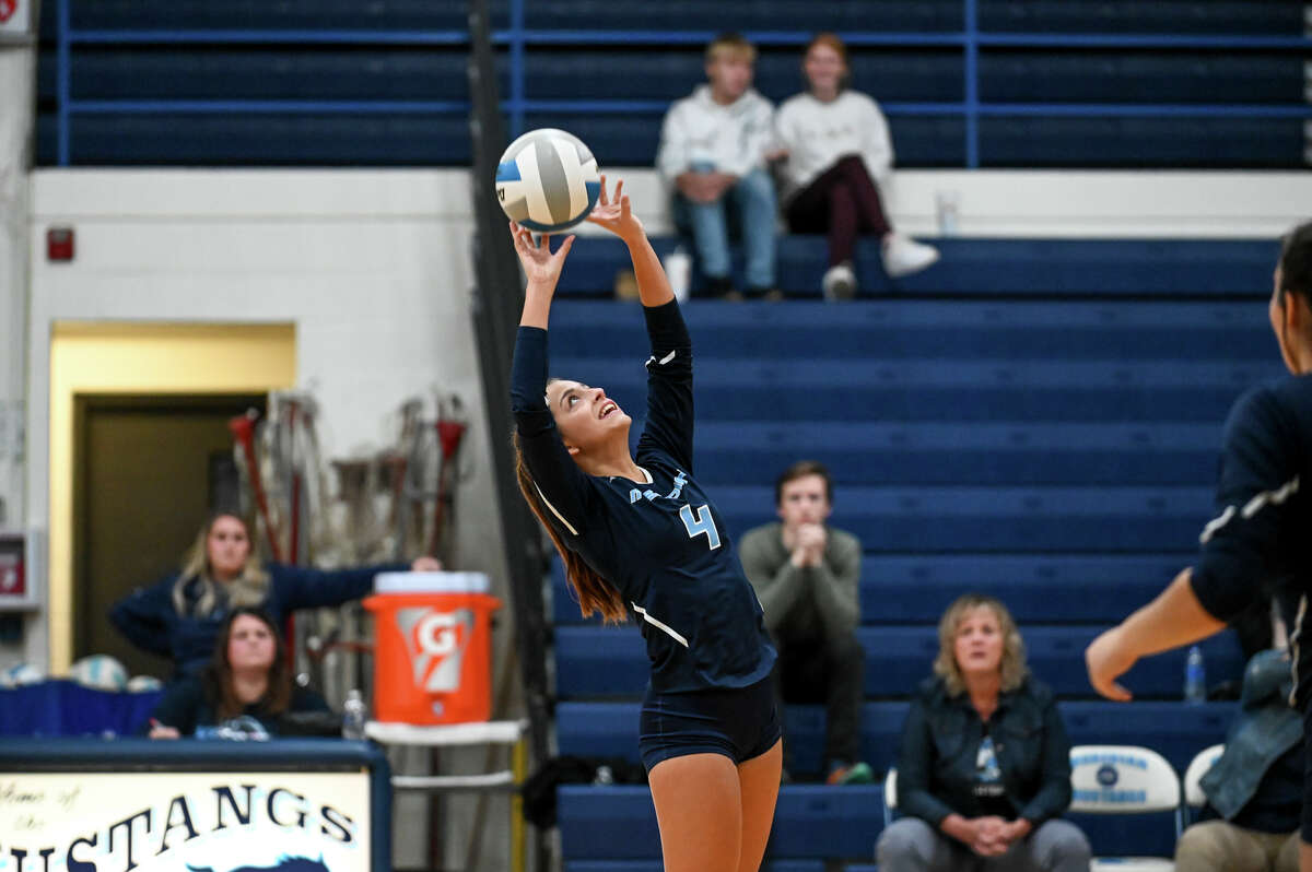 Meridian's Beth Swanton sets the ball during their district semifinal volleyball game against St. Louis Wednesday, Nov. 3, 2021 at Meridian Early College High School. (Adam Ferman/for the Daily News)