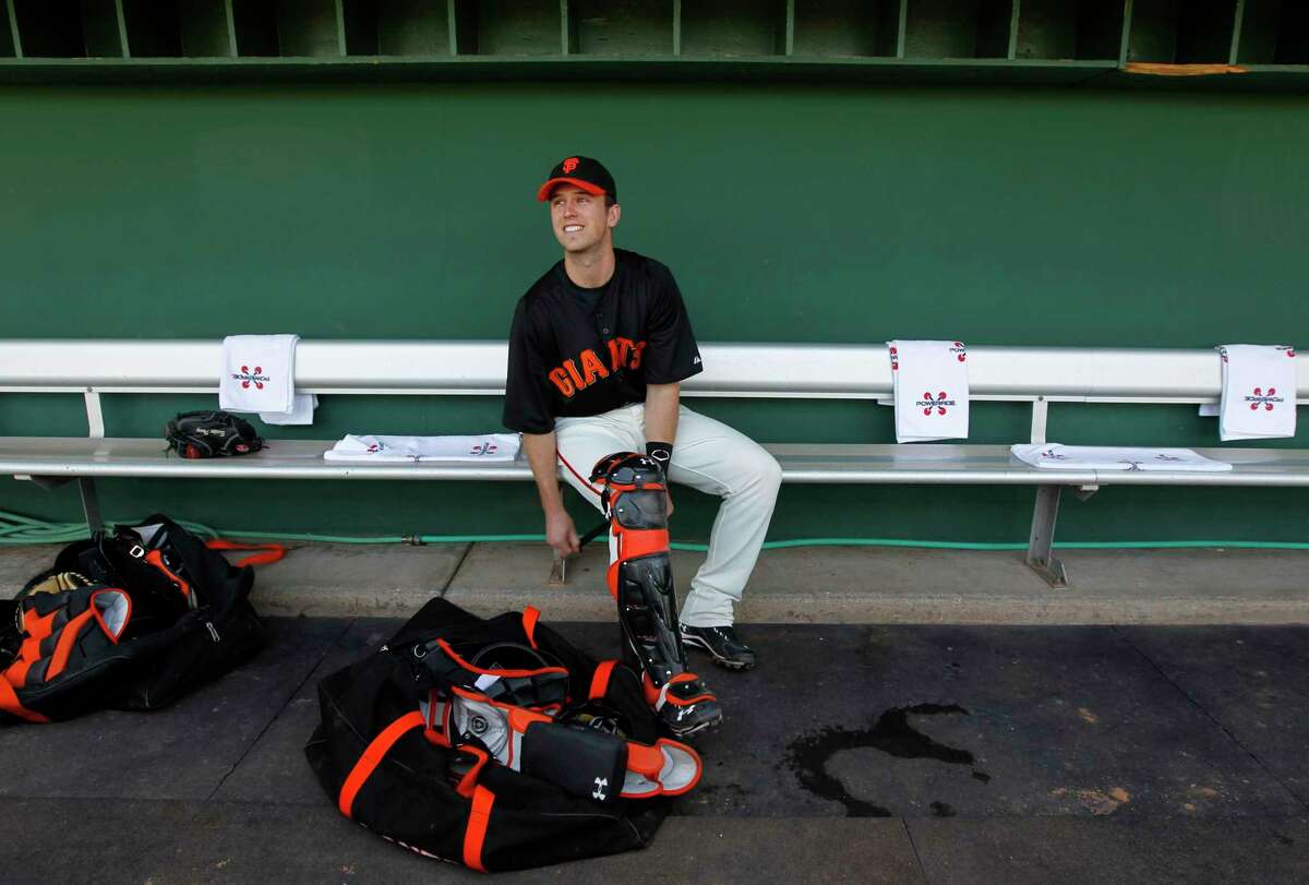 Catcher Buster Posey puts on his gear before the San Francisco Giants Cactus League spring training game against the Cincinnati Reds in Scottsdale, Ariz. on Friday, March 9, 2012. It was Posey's first game since his season-ending ankle injury last May.