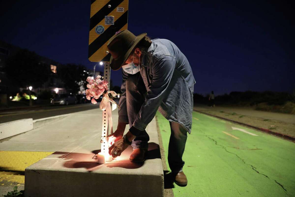 Michael Freed joined his friends to light candles on Shore Line Drive at Grand Street for Alameda Co. Supervisor Wilma Chan, who was killed by a motorist, on Wednesday, November 3, 2021, in Alameda, Calif.