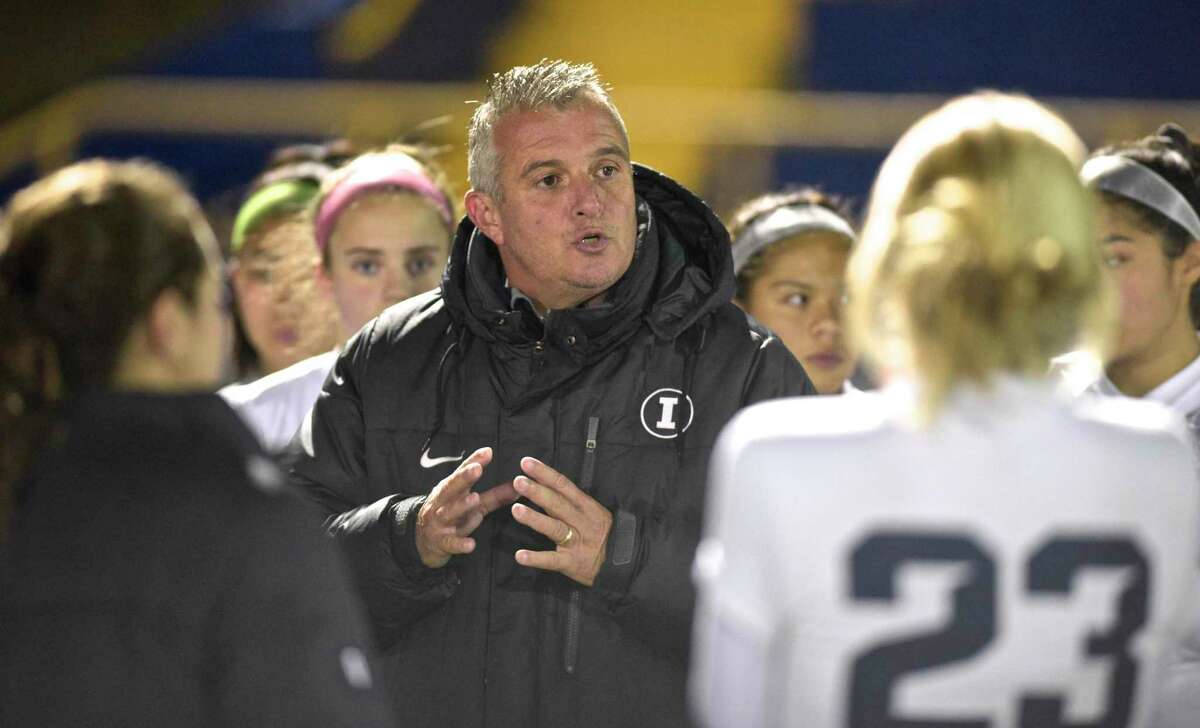 Immaculate head coach Nelson Mingachos talks with his team before the start of the SWC girls soccer game between Immaculate and Newtown high schools, Tuesday night, October 30, 2018, at Newtown High School, Newtown, Conn.