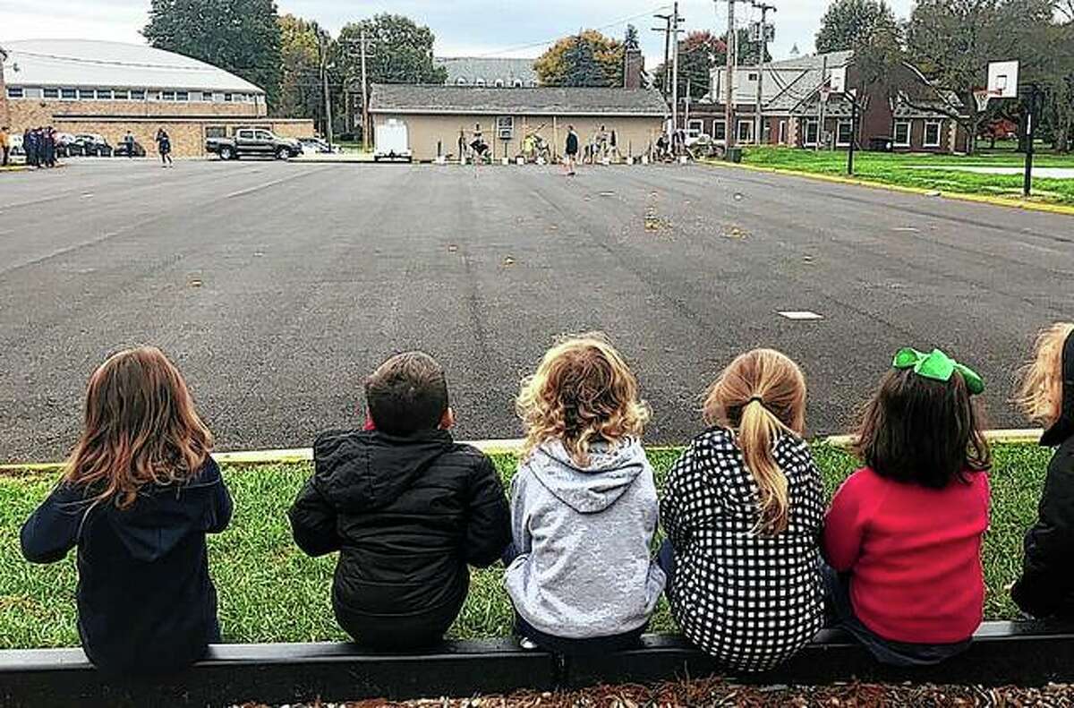 Pupils from Our Saviour School watch Monday as Routt Catholic High School students let pumpkins sail through the air as part of the annual Pumpkin Chuck.