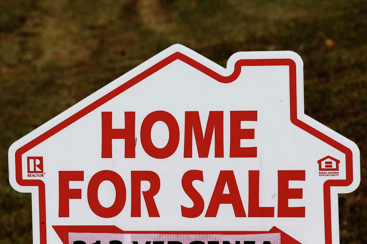 FILE - This Thursday, Oct. 17, 2019, file photo shows a house for sale sign in Orange County near Hillsborough, N.C. In Connecticut, residential real estate sales are down in October compared to the same month last year, although they’re still well above pre-pandemic levels. (AP Photo/Gerry Broome, File)