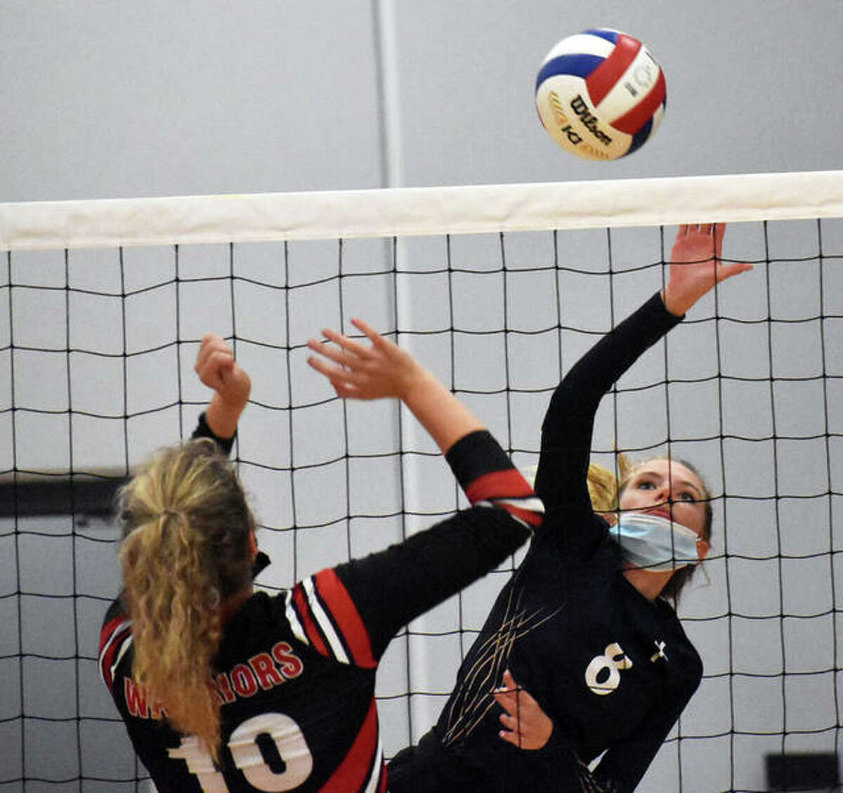 Father McGivney’s Aislin Hall goes up for an attack during a match at the season-opening Roxana Tournament.