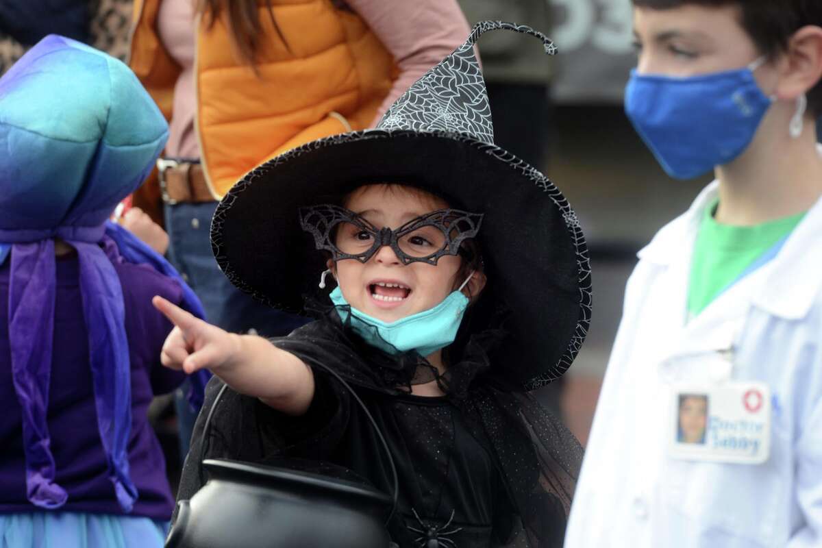 Dressed as a witch, Gracie Balzano-Porota enjoys the children’s Halloween parade on Main St. in Westport.