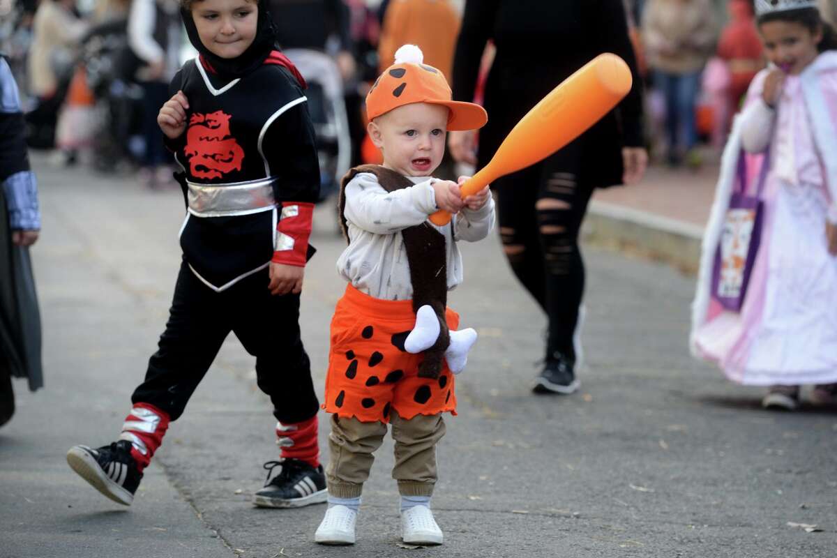 Dressed as Bamm-Bamm from the Flintstones, Colin Evans enjoys the children’s Halloween parade.