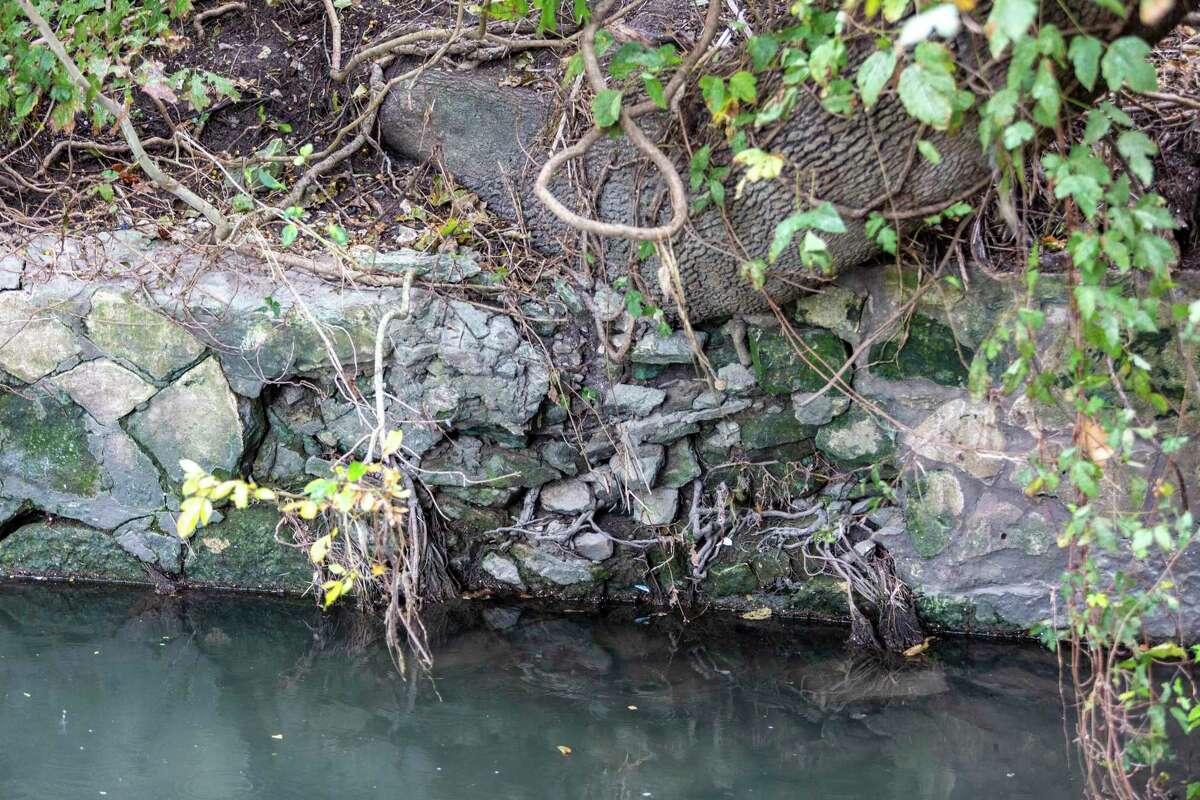 A deteriorating wall is seen Wednesday, Nov. 3, 2021 in Brackenridge Park along the banks of the San Antonio River. A cultural landscape report released this summer by the Brackenridge Park Conservancy shows the park is in decline and the conservancy is seeking input from the public to set priorities for the park that balance human uses with environmental degradation.