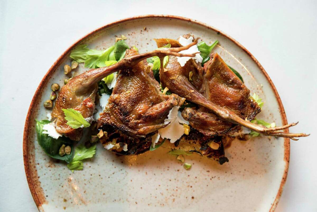 Charcoal-grilled pigeon with grilled peach, baby spinach and pistachio is seen at Oliveto in Oakland. The pioneering Cal-Italian restaurant is closing its doors for good.