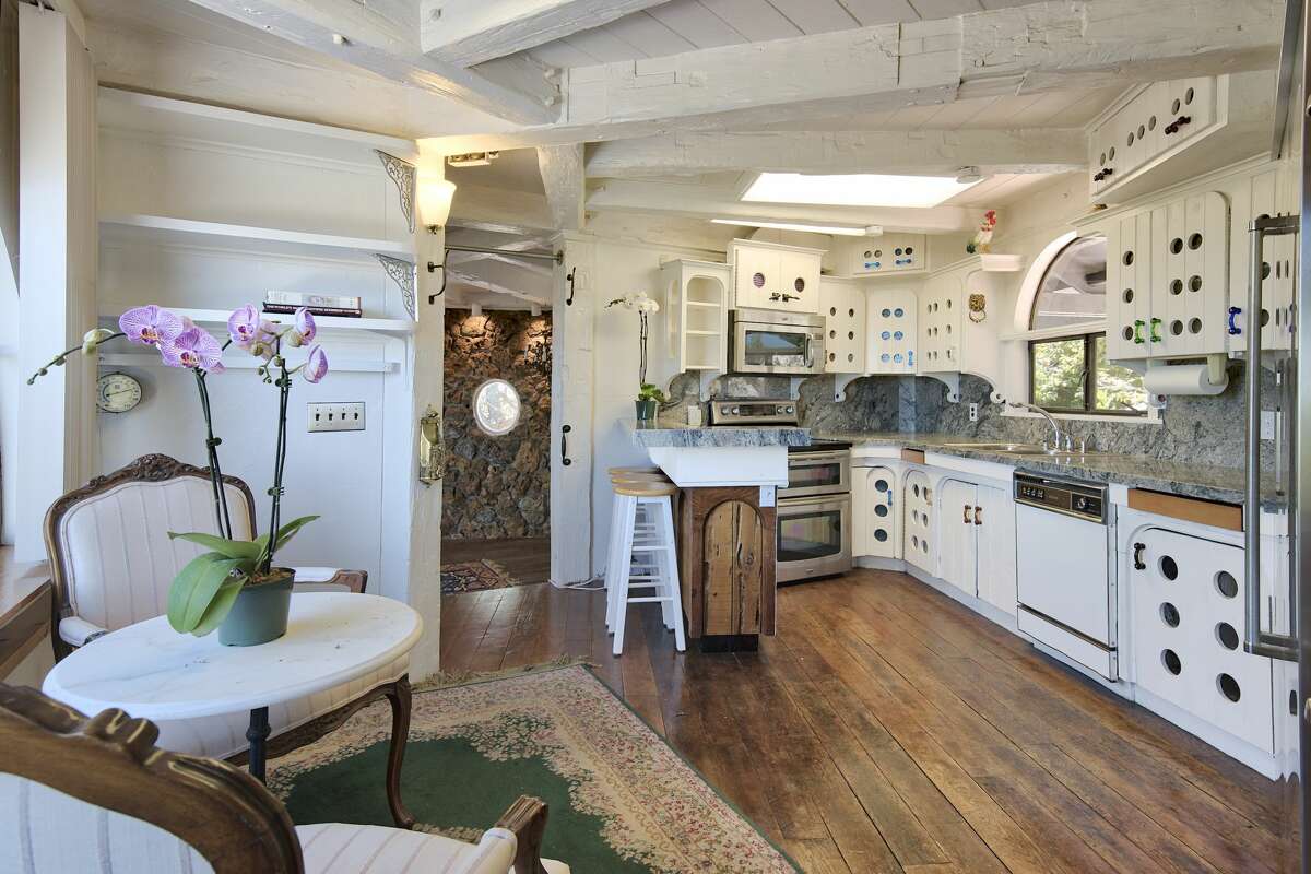 The kitchen, with its unique cabinetry and built-ins, offers both modern and vintage delights.