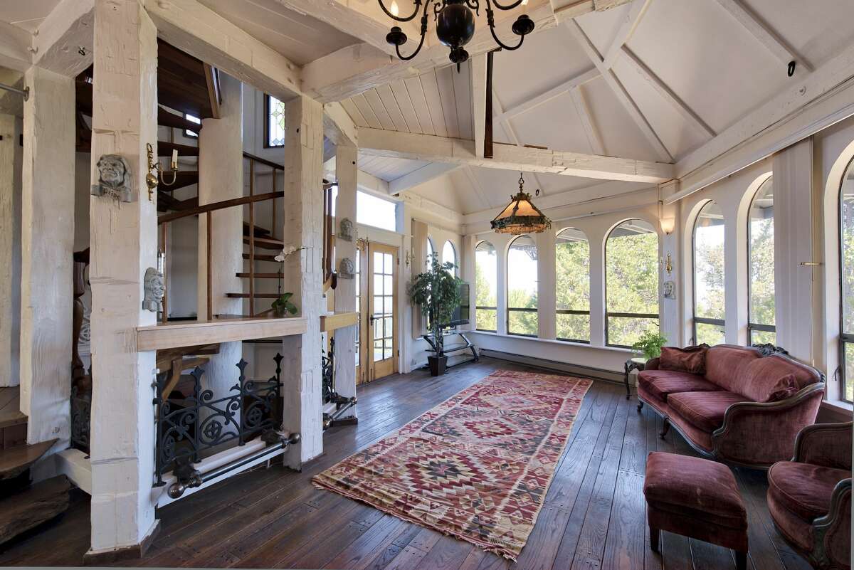 The living room ceiling soars to the many-angled top of the home, creating topography for natural light to dance around the room.