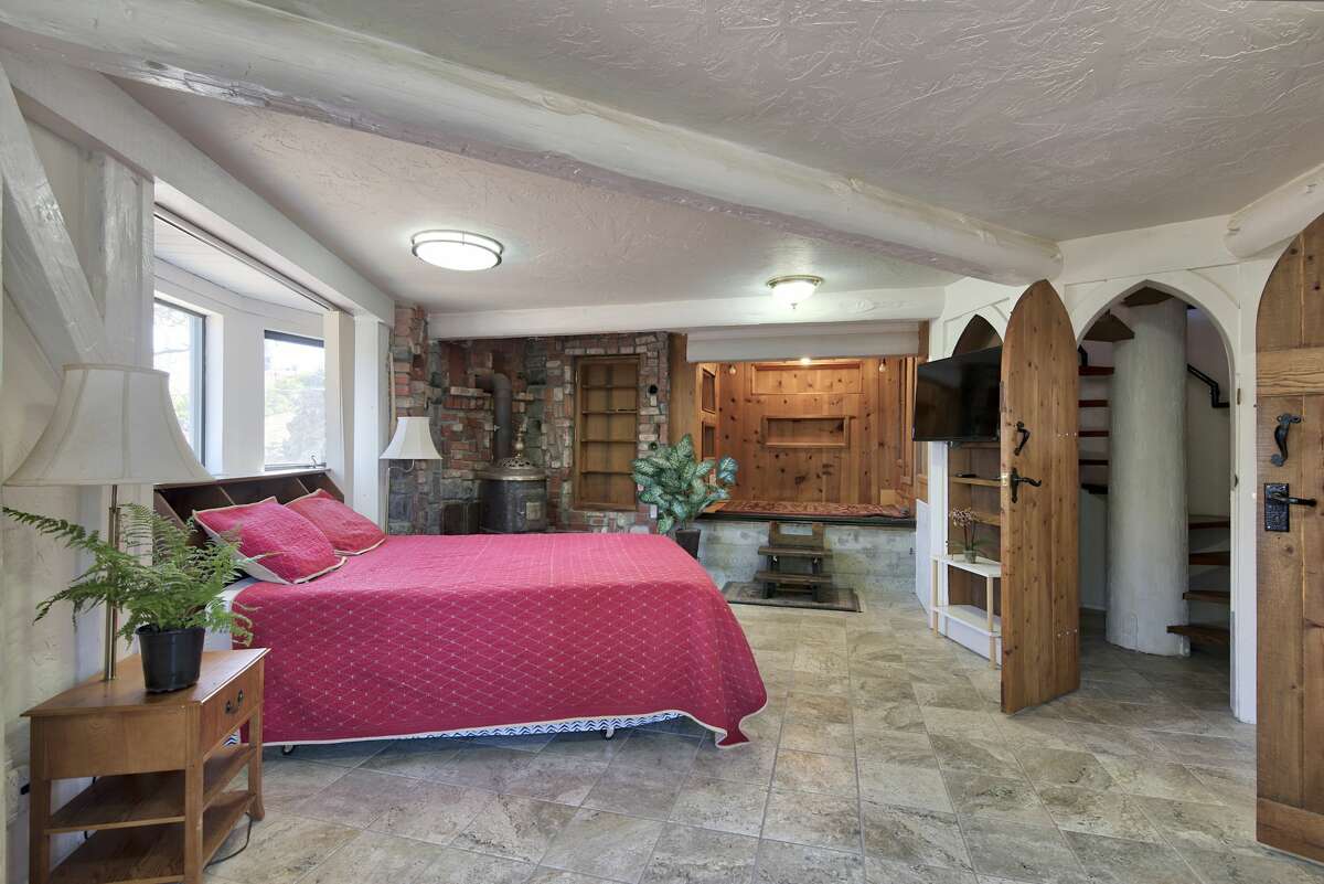 The primary bedroom has a true castle feel, tucked behind ornate wooden doors.