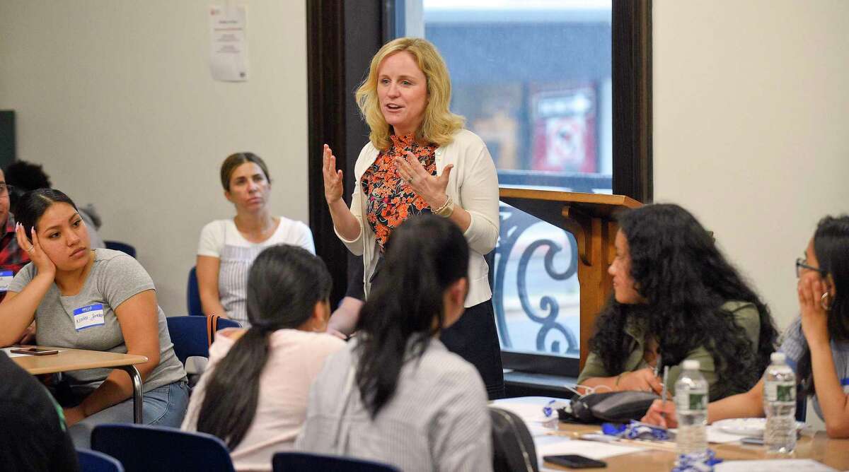 Bridget Fox, then-president of Stamford Cradle to Career, addresses recent high school graduates at a Kickoff event for a new "Bridge to College" program at Stamford's Old Town Hall on June 20, 2019.