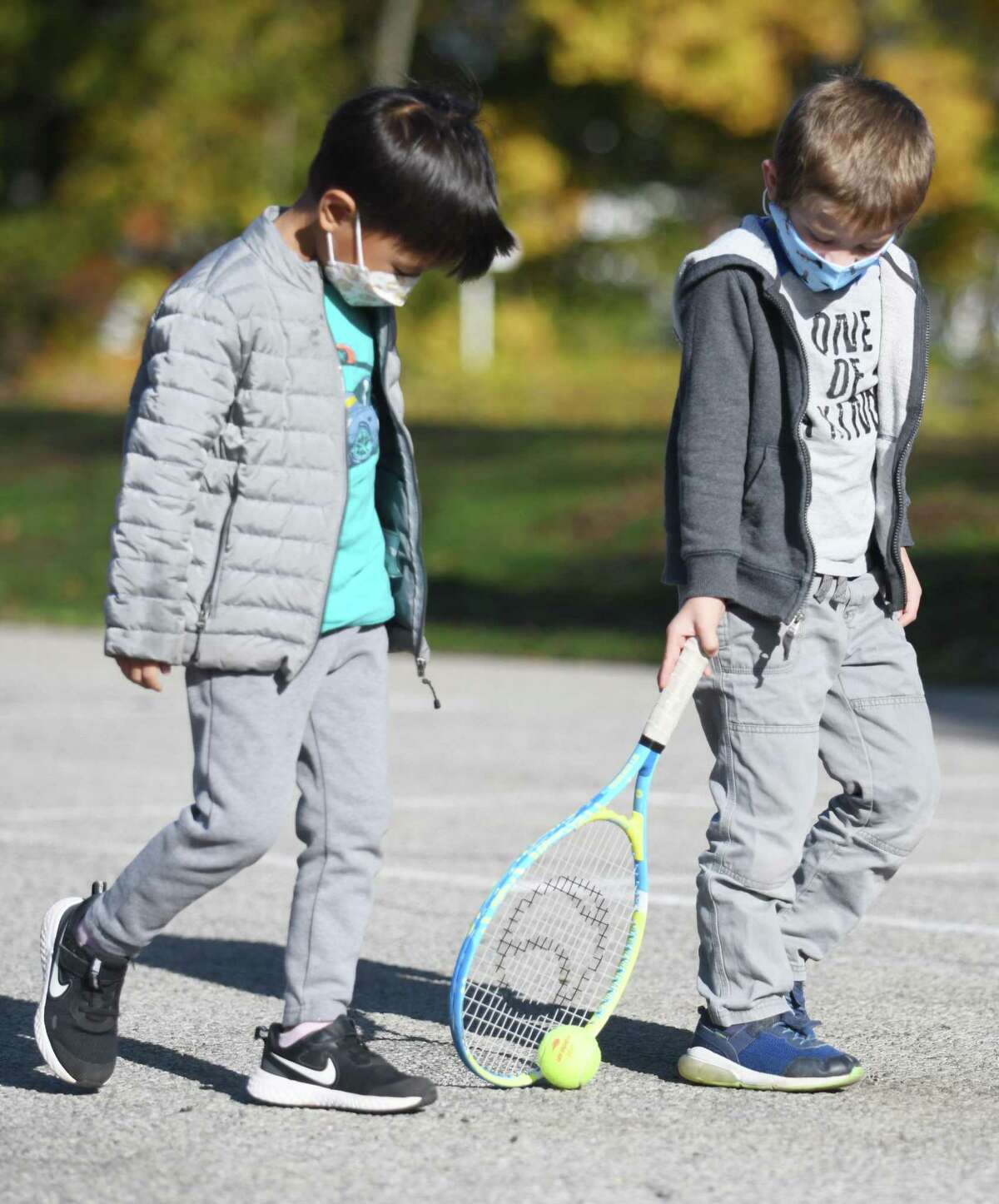 Kindergartners Sean Song, left, and Andrew Lofaro do a "walk the dog" drill during former tennis pro Eric Butorac's class for students at Cos Cob School in the Cos Cob section of Greenwich, Conn. Thursday, Nov. 4, 2021. The former tennis doubles specialist lives in Cos Cob and his children attend school in Greenwich, so he took a day to teach tennis to kids during gym class at Cos Cob School. The students learned the basics of tennis and completed drills individually and in small groups.