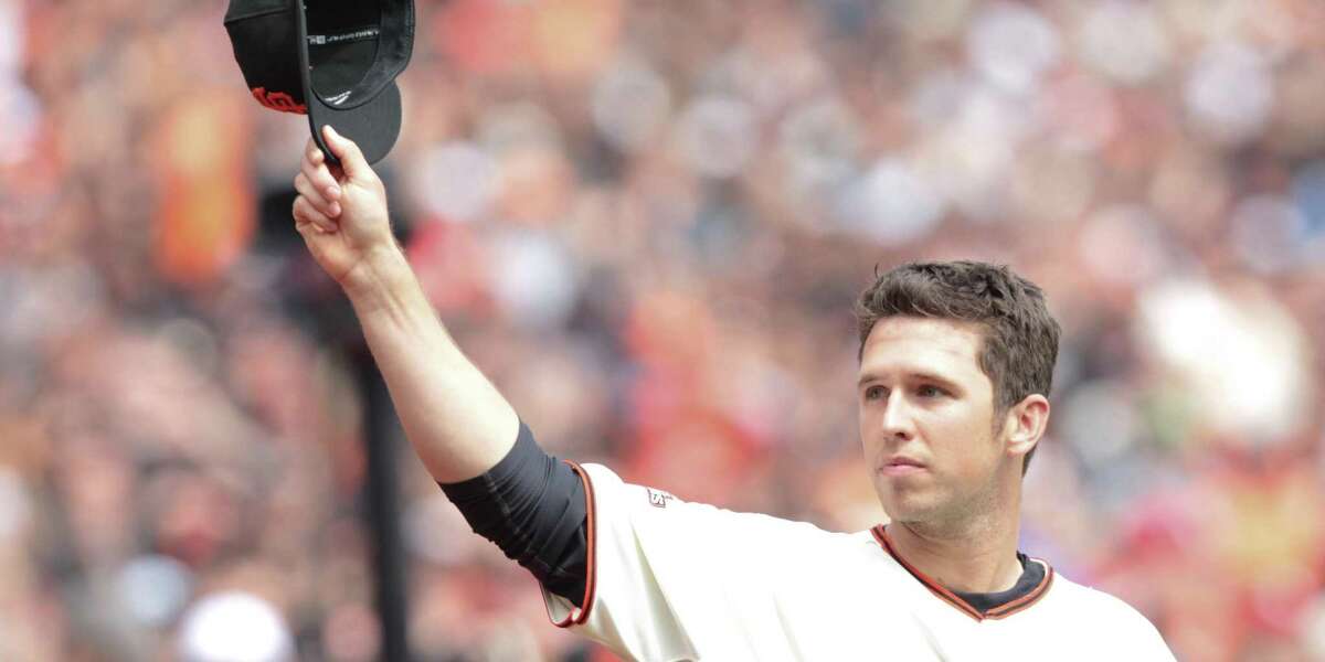 Buster Posey acknowledges the fans during a ceremony to accept his 2012 National League MVP Award in April 2013 at what was then AT&T Park in San Francisco.