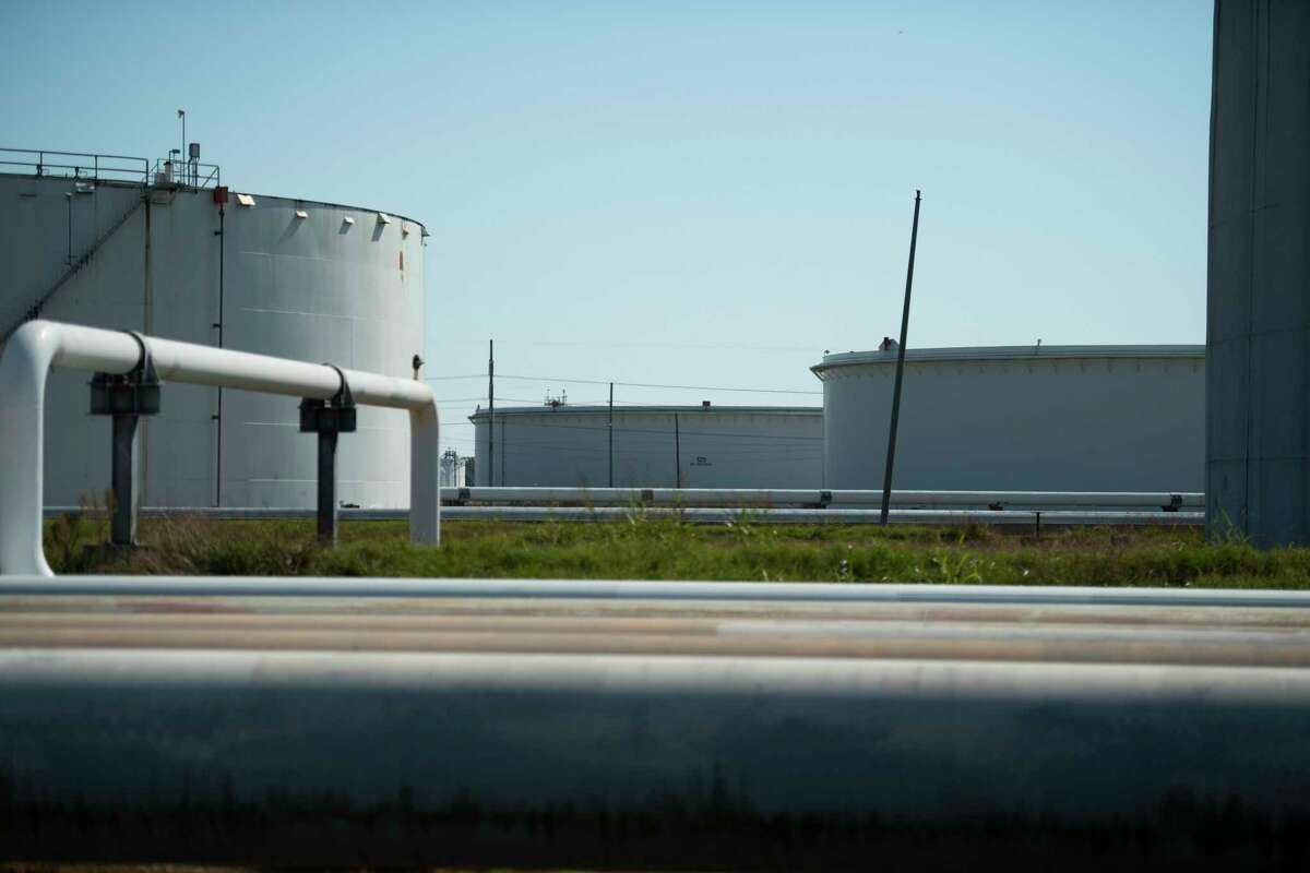 Crude oil storage tanks and their associated pipelines hold oil awaiting transport at the Energy Transfer Nederland Terminal Tuesday, Nov. 2, 2021, in Nederland, Texas.
