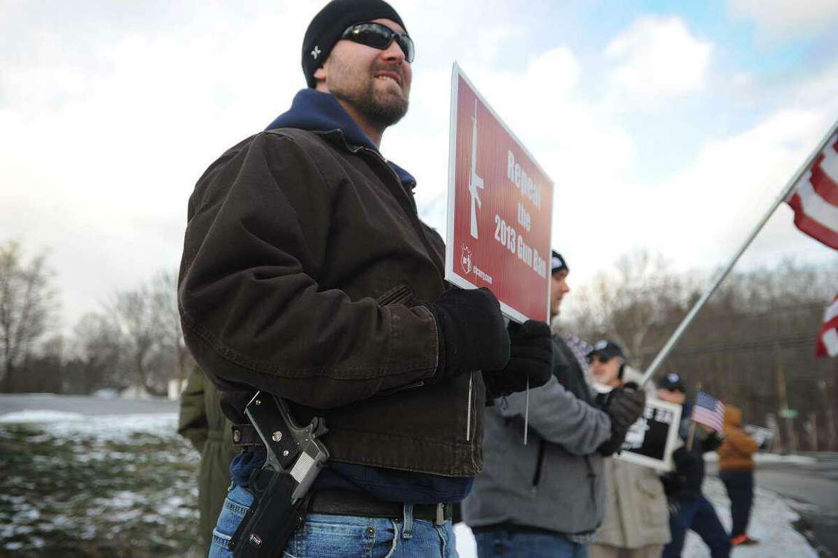 Robert Harris, of Old Saybrook, openly carries his weapon as he and fellow gun-rights advocates oppose a gun-control rally outside the National Shooting Sports Foundation’s headquarters in Newtown, Conn. on January 18, 2016.
