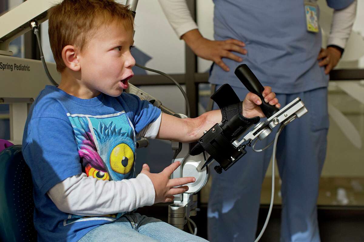Ryland Ward, who was shot in the Sutherland Springs massacre, plays a video game as part of his occupational therapy at Children's Rehabilitation Institute TeletonUSA in San Antonio on Nov. 1, 2018.