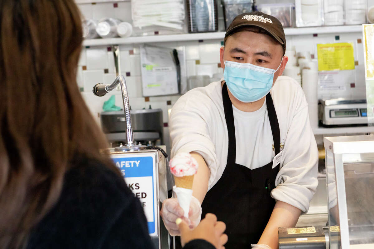 ice cream cone Henry Luo hands an <a class=