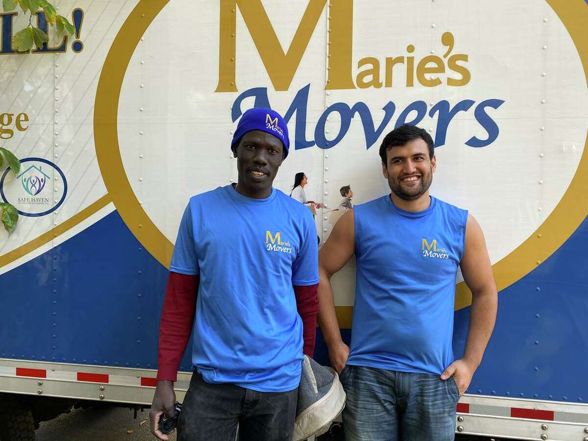 Anur Abdemma, left, from Sudan and Javid, an Afghan who arrived from Turkey, are now living in Connecticut and working for Marie’s Movers, helping other refugees.