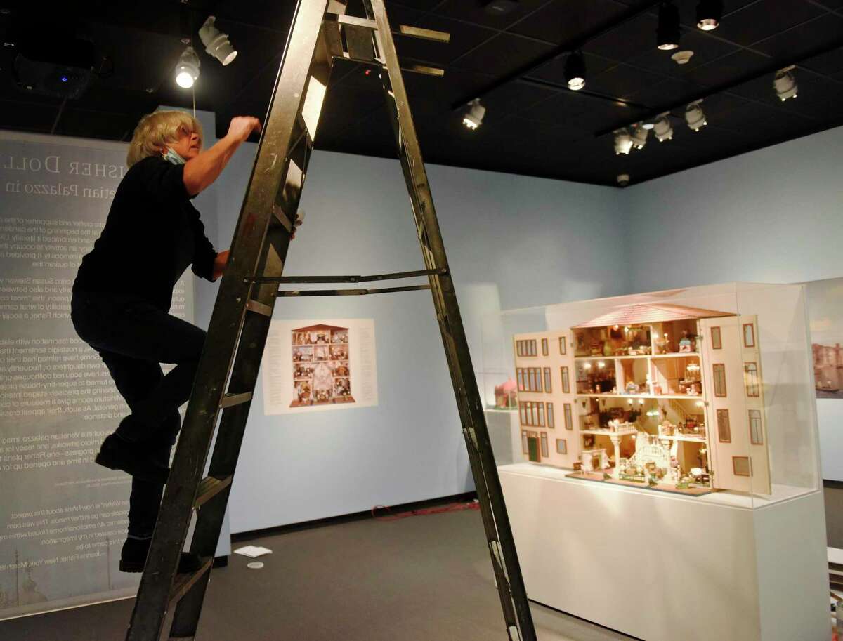 Director of Exhibitions Anne von Stuelpnagel sets up lighting for the new exhibit "The Fisher Dollhouse: A Venetian Palazzo in Miniature" at the Bruce Museum in Greenwich, Conn. Wednesday, Nov. 3, 2021. The Bruce Museum is opening two new exhibitions on Nov. 7. "Resolute: Native Nations Art in the Bruce Collection" features significant objects that provide new information about Native Nations as historical and contemporary societies."The Fisher Dollhouse: A Venetian Palazzo in Miniature" features miniature renderings of 10 rooms inside a diorama inspired by Venice's glamorous Gritti Palace.