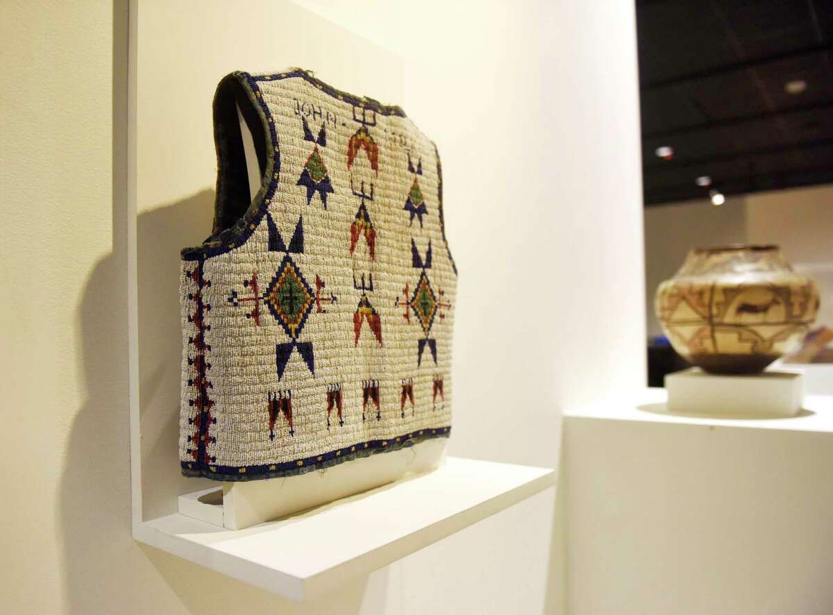 A beaded vest made by Hattie Long Horn is displayed at the new exhibit "Resolute: Native Nations Art in the Bruce Collection" at the Bruce Museum in Greenwich, Conn. Wednesday, Nov. 3, 2021. The Bruce Museum is opening two new exhibitions on Nov. 7. "Resolute: Native Nations Art in the Bruce Collection" features significant objects that provide new information about Native Nations as historical and contemporary societies."The Fisher Dollhouse: A Venetian Palazzo in Miniature" features miniature renderings of 10 rooms inside a diorama inspired by Venice's glamorous Gritti Palace.