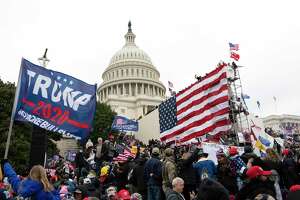 Violent insurrectionists stand outside the U.S. Capitol in Washington on Jan. 6, 2021.