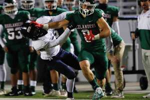 The Woodlands wide receiver Ben Ferguson (6) stiff-arms College Park defensive back Dylan Moore (29) on his way to a 41-yard gain during the second quarter of a high school football game at Woodforest Bank Stadium, Thursday, Nov. 4, 2021.