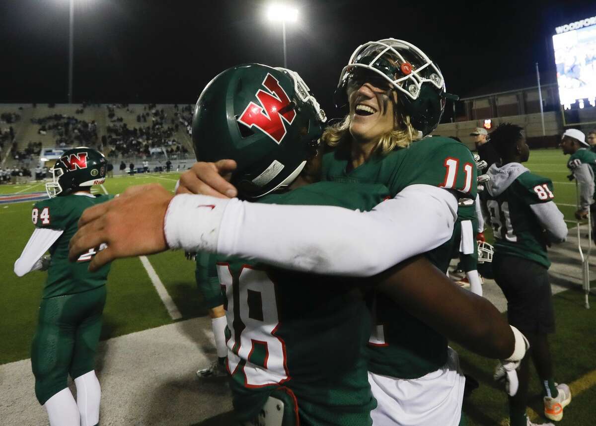 The Woodlands quarterback Mabrey Mettauer (11) celebrates with defensive linemen Bradley Warren (98) after defeating College Park 45-14 to win the District 13-6A championship at Woodforest Bank Stadium, Thursday, Nov. 4, 2021.
