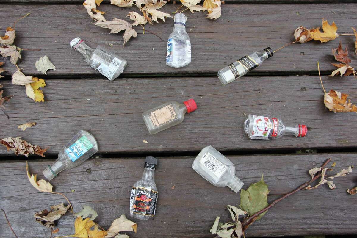 Empty nips bottles collected on a recent walk in a residential neighborhood in New London. A first-in-the-nation stewardship program places a 5-cent environmental fee on the sale of each nip container sold in Connecticut.