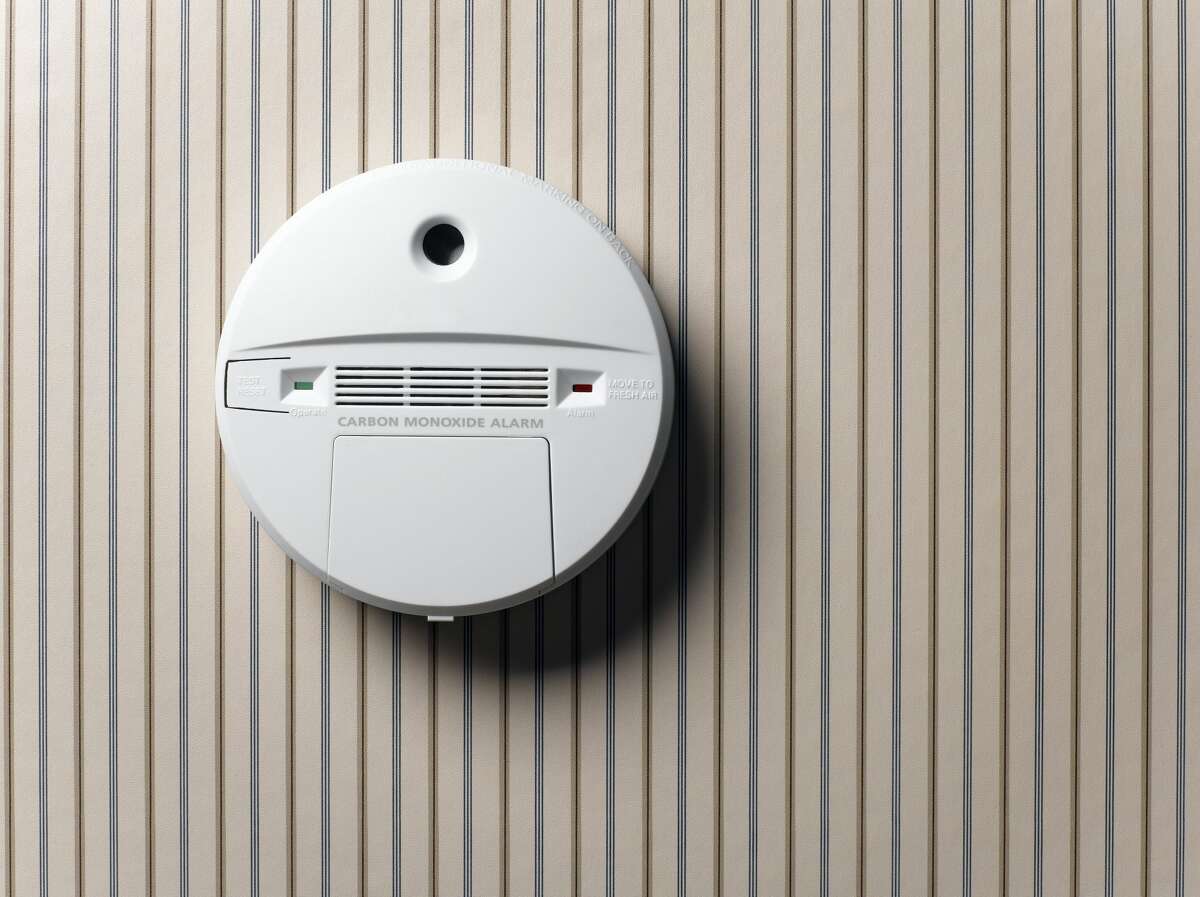 A file image of a smoke alarm on a wall.