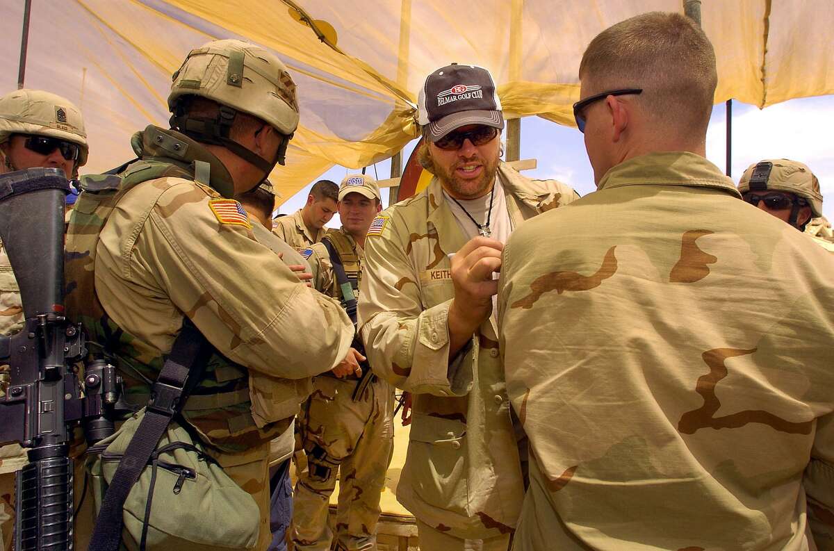 Country music star Toby Keith signs autographs in Iraq in 2005. Should he be part of an Iraq soundtrack?