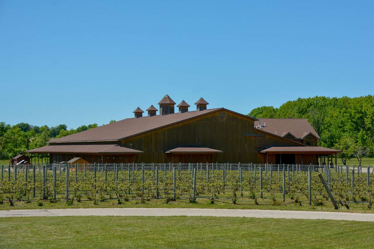 Pictured are the vineyard and barn.