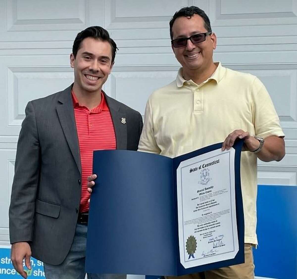 The employees and volunteers of Housatonic Habitat for Humanity dedicated a house to a new homeowner, Fernando Franco. State Rep. David Arconti, D-Danbury is pictured, left, next to Franco.