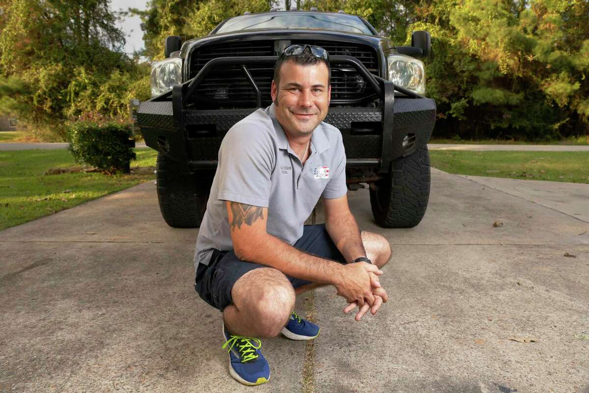 Wade Julian with his dually diesel truck in his home driveway Tuesday, Nov. 2, 2021 in Magnolia, TX.