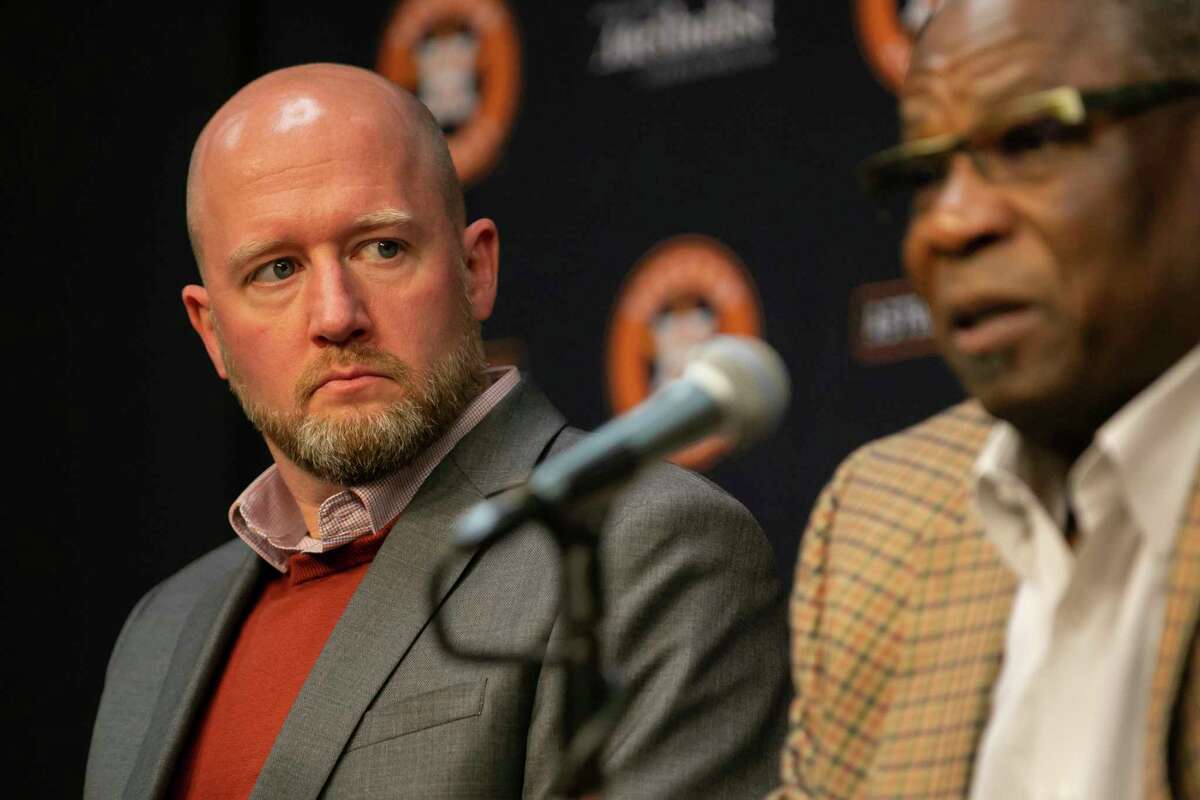 Astros general manager James Click listens as manager Dusty Baker answers a question during a press conference with team owner Jim Crane announcing that Baker has signed a new, one-year contract, Friday, Nov. 5, 2021, at Minute Maid Park in Houston.