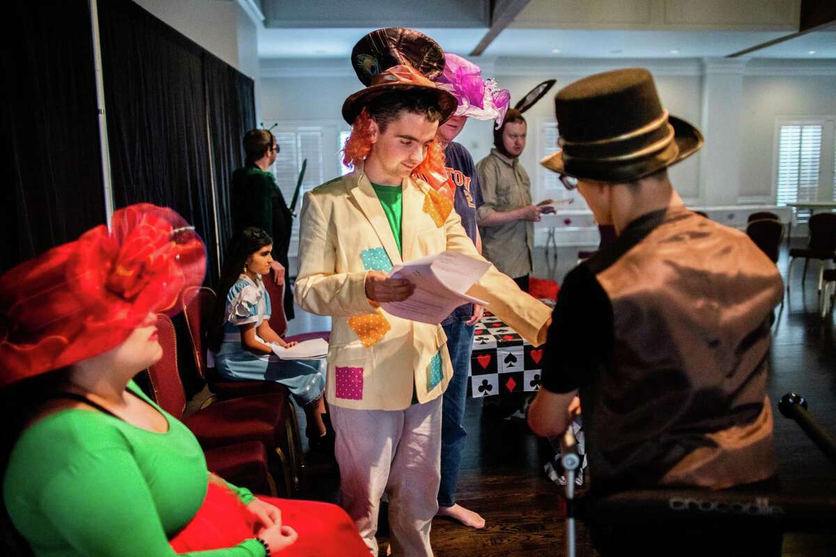 Garrett Anthony, center, 18, practices his role of Mad Hatter during rehearsal of the Mad Tea Party ahead of the performance, Sunday, Oct. 3, 2021, in Houston. The performance is part of the Better Together Performing Arts Academy. The performance was at the Holy Rosary Church fellowship hall.