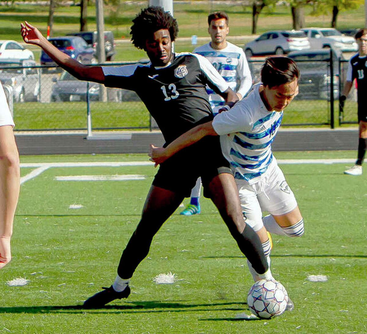 Jahari Lawrence of Lewis and Clark, left and Iowa Western’s Arata Saegusa battle for the ball during Friday’s NJCAA Division I Midwest district Tournament semifinals in Council Bluffs, Iowa.