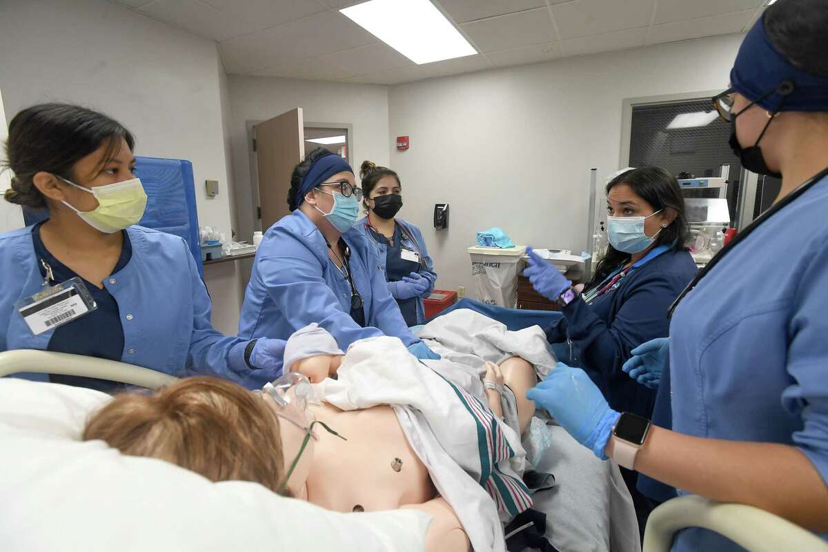 Nursing students at Lamar State College Port Arthur, including (from left) Kelly Jaramillo, Brandy Maxwell, Edith Del Angel and Ashlynn Ortiz listen as instructor Andrea Reyes offers advice on procedures as they run through a postpartum hemorrhage scenario during a morning lab Friday. Photo made Friday, November 5, 2021 Kim Brent/The Enterprise