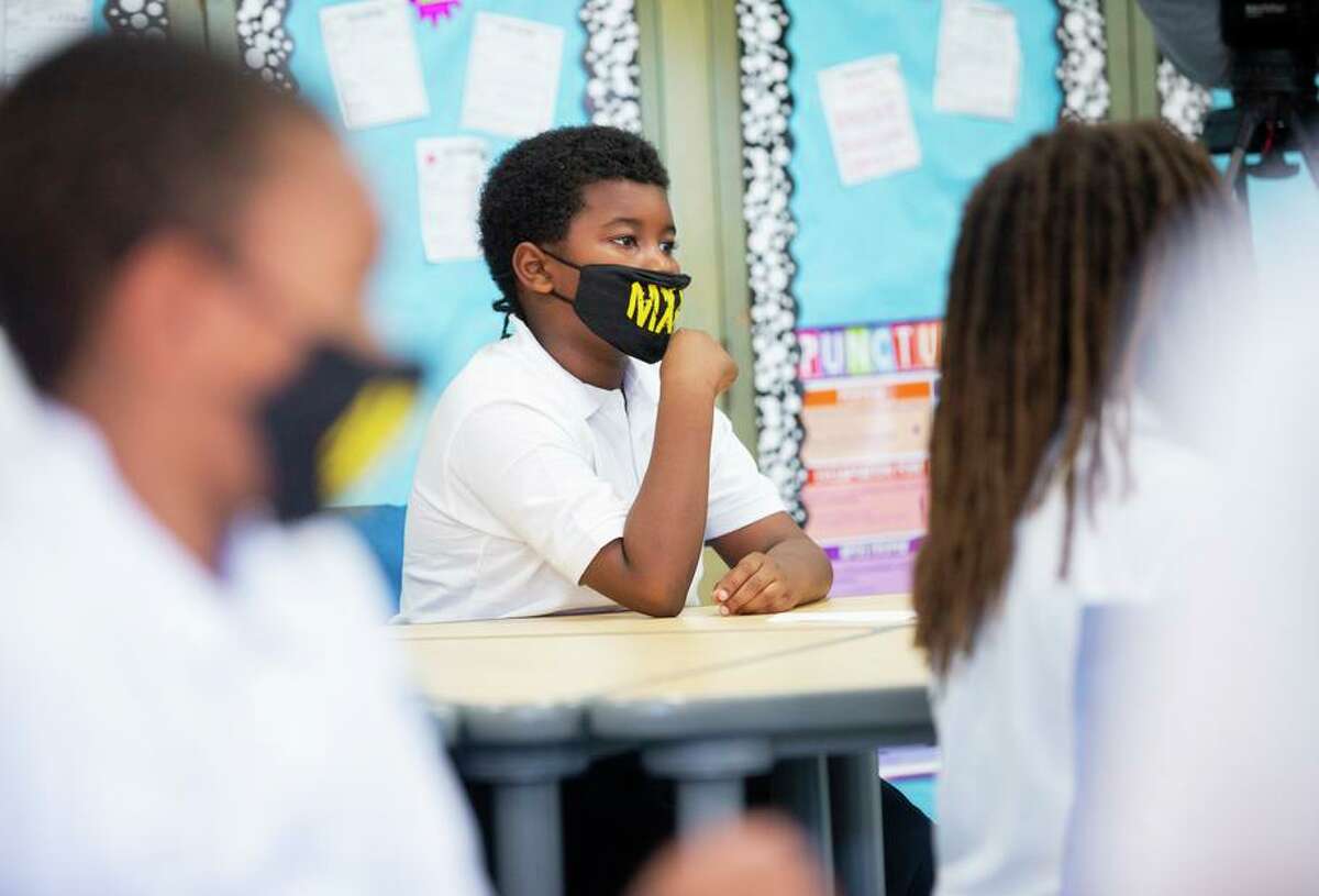 State health officials have not said when kids, such as these at Malcolm X Academy, can stop wearing masks at school.