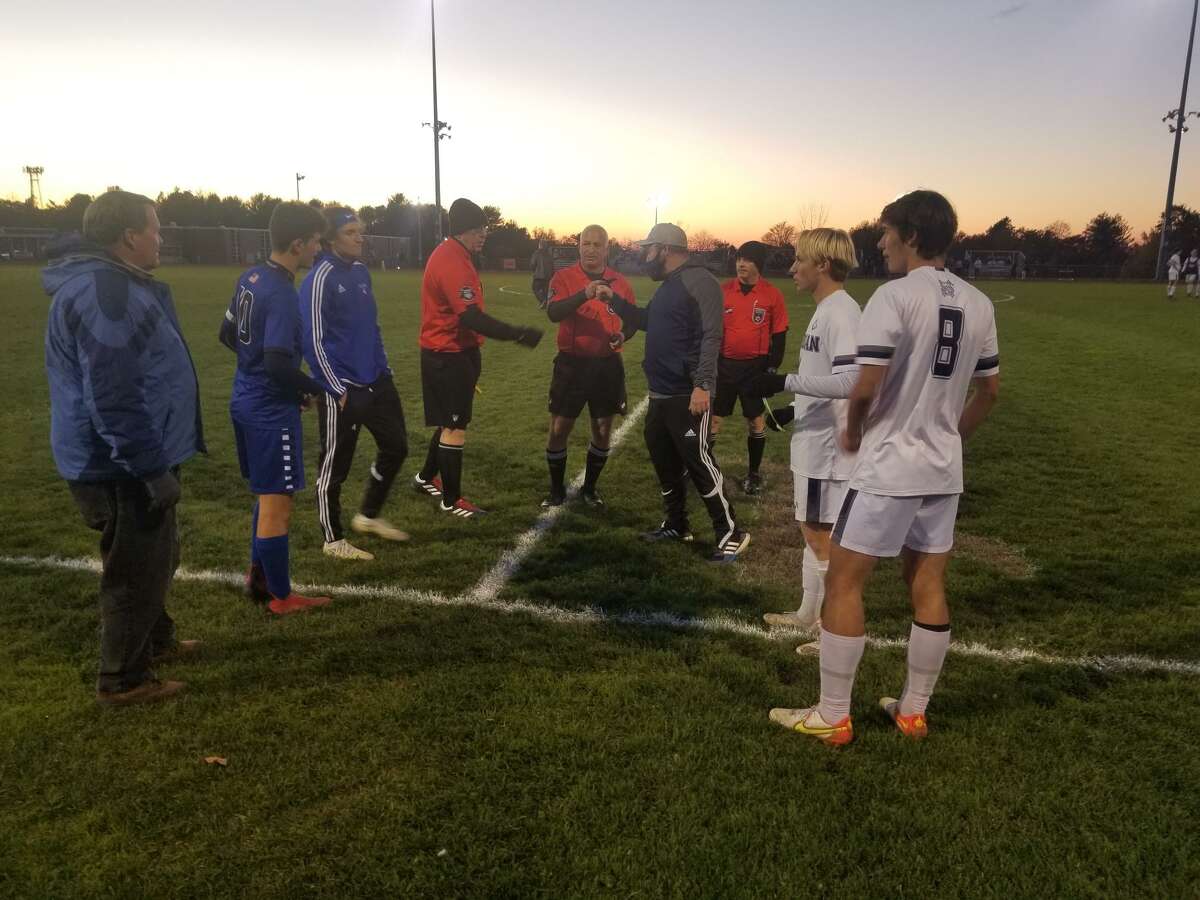 The coaches and captains for both Old Saybrook, left, and Morgan meet with the officials in the pregame before the Shoreline Conference tournament final at Portland High on Friday.