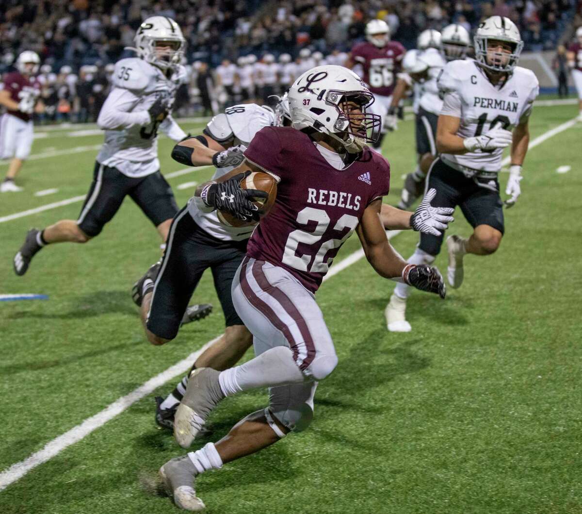 Legacy’s Makhilyn Young (22) runs the ball as Permian’s Deonte Bass attempts to push him out of bounds on Friday, Nov. 5, 2021 at Grande Communications Stadium. Jacy Lewis/Reporter-Telegram